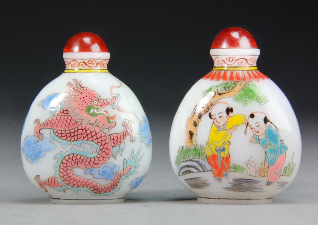 (2) Peking Glass Snuff Bottles: Finely painted to depict boys at play within a landscape, second depicting dragons among clouds, base bearing 4 character mark in red, 2.75"H. Condition: good, both with stoppers.