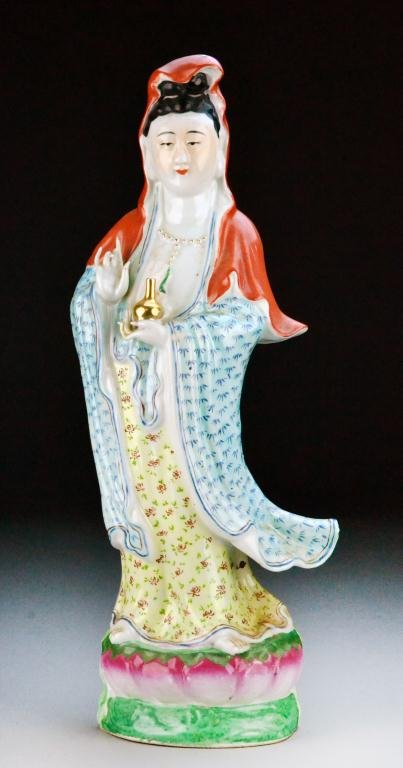 Chinese Republic Famille Rose Porcelain Guan Yin: Standing on lotus base, left hand holding a vase, right hand in Buddhist Mudra, impressed shop mark to base, 16.5"H, circa early 20th century. Condition, with left hand index finger with restoration. 