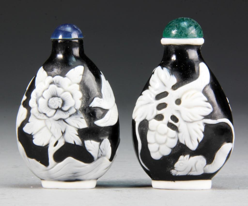 (2) Pcs Chinese Peking Glass Snuff Bottles: Each having white over black appliqued decoration, one depicting grapes and vines with squirrel, the other birds perched with flowering branches, largest measures 2.75"H.