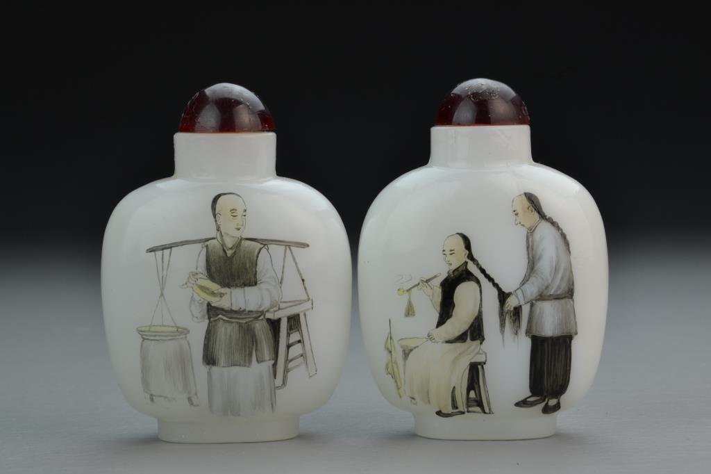 (2) Chinese Peking Glass Snuff Bottles: Finely painted to depict gentleman with pipe and male figure carrying stool and pot on reverse, complete with stoppers, 3.5"H. From the collection of David Bell who worked for an Italian steel company