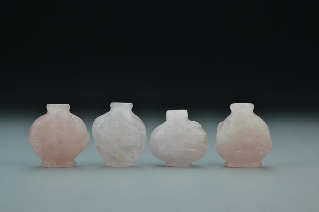(4) Chinese Carved Rose Quartz Snuff Bottles: Carved with depictions of foliage, lizard, bat, double gourd, peach and ruyi , lacking stoppers, tallest is 1.9"H. From the collection of David Bell who worked for an Italian steel company in China du