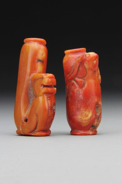 (2) Chinese Carved Coral Snuff Bottles: To include two finely carved bottles with protruding forms of rabbit head and dragon, good aged color, lacking stoppers, tallest is 2.6"H. From the collection of David Bell who worked for an Italian s