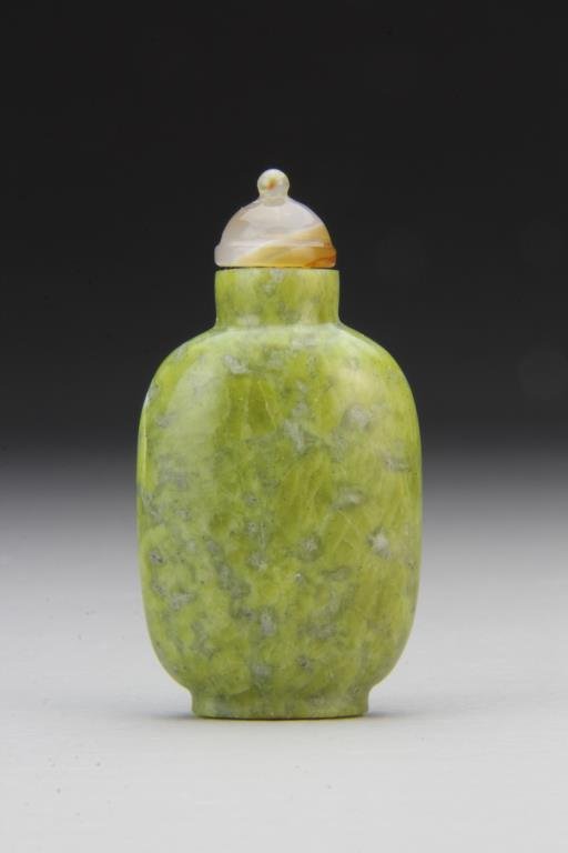 Chinese Carved Agate Snuff Bottle: Finely polished and carved of simple form, showing natural properties of the stone, complete with agate stopper, 2.8"H. From the collection of David Bell who worked for an Italian steel company in Chi