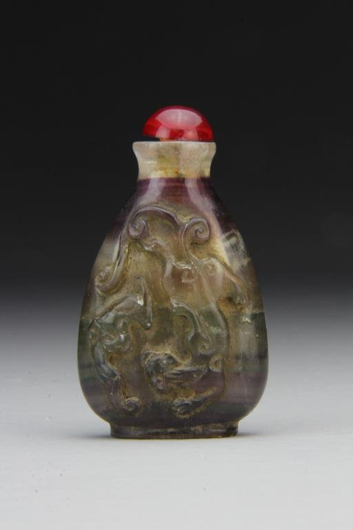 Chinese Carved Rock Crystal Snuff Bottle: Finely carved to depict bat and lion, polished to show natural purple properties of crystal, complete with stopper, 3.2"H. From the collection of David Bell who worked for an Italian steel company in 