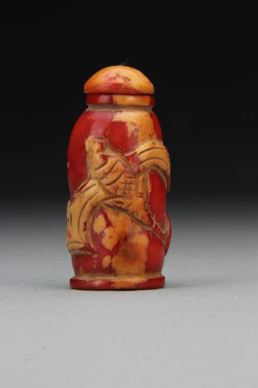 Chinese Carved Coral Snuff Bottle: Finely carved to depict bat and fruit, having smooth polished surface, complete with matching stopper, 2.4"H. From the collection of David Bell who worked for an Italian steel company in China during 