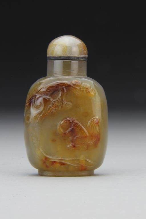 Chinese Carved Agate Snuff Bottle: Finely polished and carved to depict squirrel beneath ancient tree, complete with matching stopper, 2.9"H. From the collection of David Bell who worked for an Italian steel company in China during the