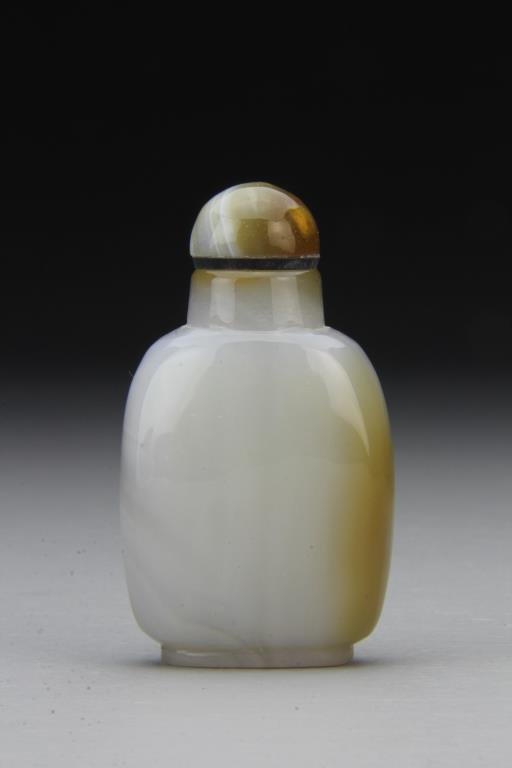 Chinese Carved Agate Snuff Bottle: Finely polished and carved of simple form to show natural properties of the stone, complete with stone stopper, 3.75"H. From the collection of David Bell who worked for an Italian steel company in Chi