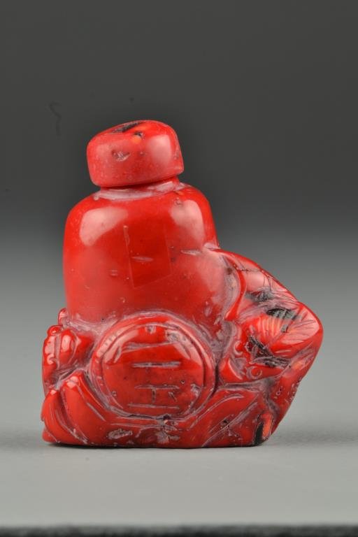 Chinese Carved Coral Snuff Bottle: Finely carved to depict bats, smooth polished surface, damaged on side, complete with matching stopper, 3"H. From the collection of David Bell who worked for an Italian steel company in China during t