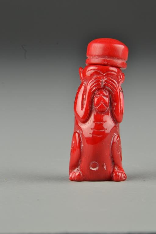 Chinese Carved Coral Snuff Bottle: Finely carved to depict "see no evil"monkey, smooth polished surface, great condition, complete with matching stopper and spoon, 2.4"H. From the collection of David Bell who worked for an Italian stee