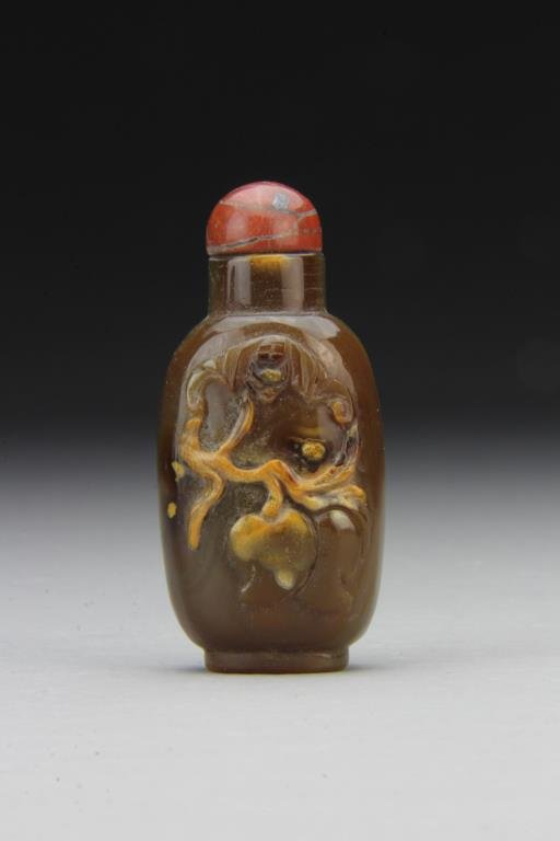 Chinese Carved Agate Snuff Bottle: Finely polished and carved to depict bat and peach, complete with stopper, 2.6"H. From the collection of David Bell who worked for an Italian steel company in China during the 1980's.