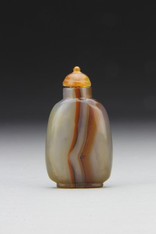 Chinese Carved Agate Snuff Bottle: Finely polished and carved of simple form to show natural properties of stone, complete with matching stopper, 2.3"H. From the collection of David Bell who worked for an Italian steel company in China