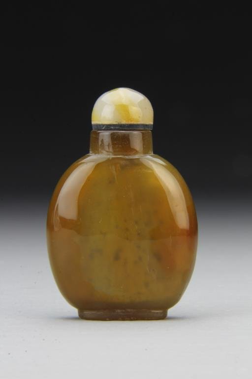 Chinese Carved Agate Snuff Bottle: Finely polished and carved of simple form to show natural properties of stone, complete with matching stopper, 2.5"H. From the collection of David Bell who worked for an Italian steel company in China