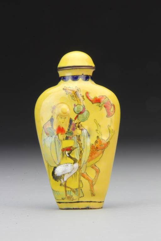 Chinese Enamel Snuff Bottle: Finely molded and painted to depict figure with bat, deer and crane , bats surrounding symbol on reverse, complete with matching stopper, 3.2"H. From the collection of David Bell who worked for an Ita