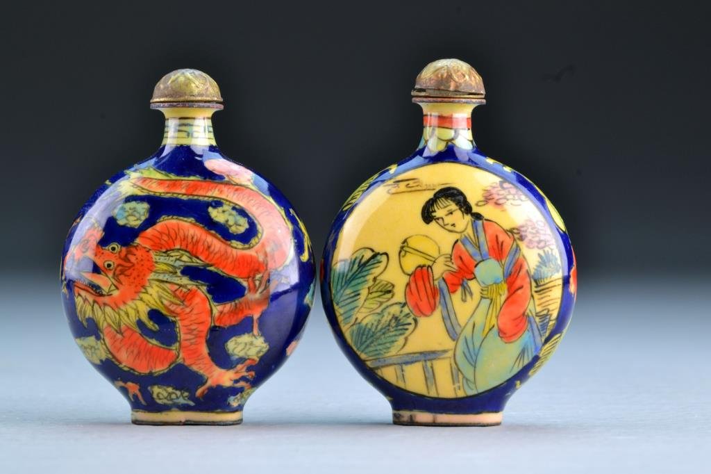 (2) Chinese Enamel Snuff Bottles: One painted to depict four clawed dragons chasing a flaming pearl among ruyi clouds, second depicting beauties in landscape scenes at center, tallest is 2.5"H. From the collection of David Bell who wo