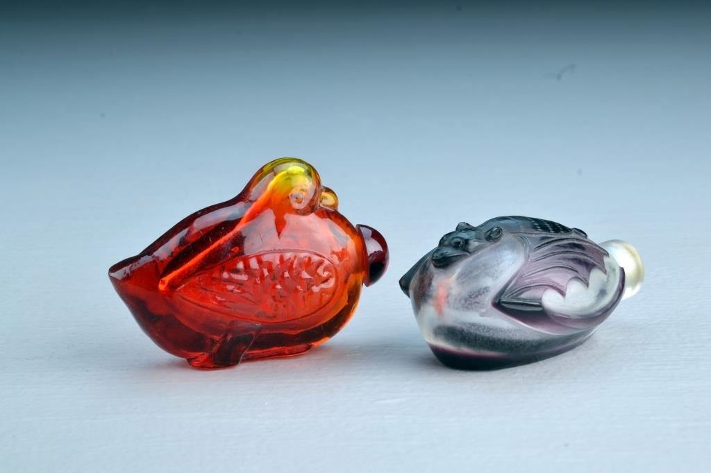 (2) Chinese Peking Glass Snuff Bottles: Two horizontal examples, one finely molded into shape of a bird, other having overlay in form of a bat, largest is 3"L. From the collection of David Bell who worked for an Italian steel company in Chi