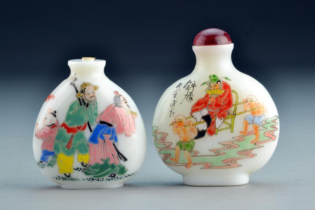 (2) Chinese Peking Glass Snuff Bottles: One finely painted to depict figures with deer and bats, base bearing four character mark, other depicting nobility and servants with calligraphy and red seals and a base bearing three character mark 