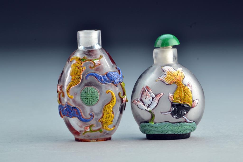 (2) Chinese Peking Glass Snuff Bottles: Each having painted overlay, one depicting bats and symbol with flowers, other depicting fish and lotus over water, tallest is 2.7"H. From the collection of David Bell who worked for an Italian steel 