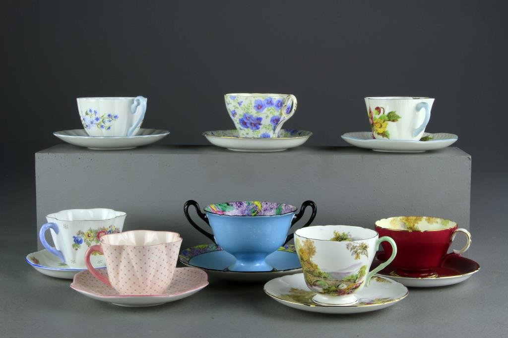(14) Sets Of Shelley Porcelain Cups & Saucers: To include various colors and patterns including a two handled loving cup and saucer, largest measures 6"W, condition excellent in need of cleaning. Private collection Oxford, Michigan.