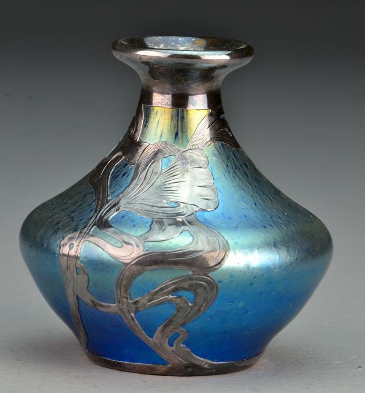 A Loetz Quality Silver Overlay Glass Vase: Having an iridescent glass overlayed with art nouveau silver decoration, and having a polished pontil, 3.5"H. Private Collection, Lake Orion, Michigan.