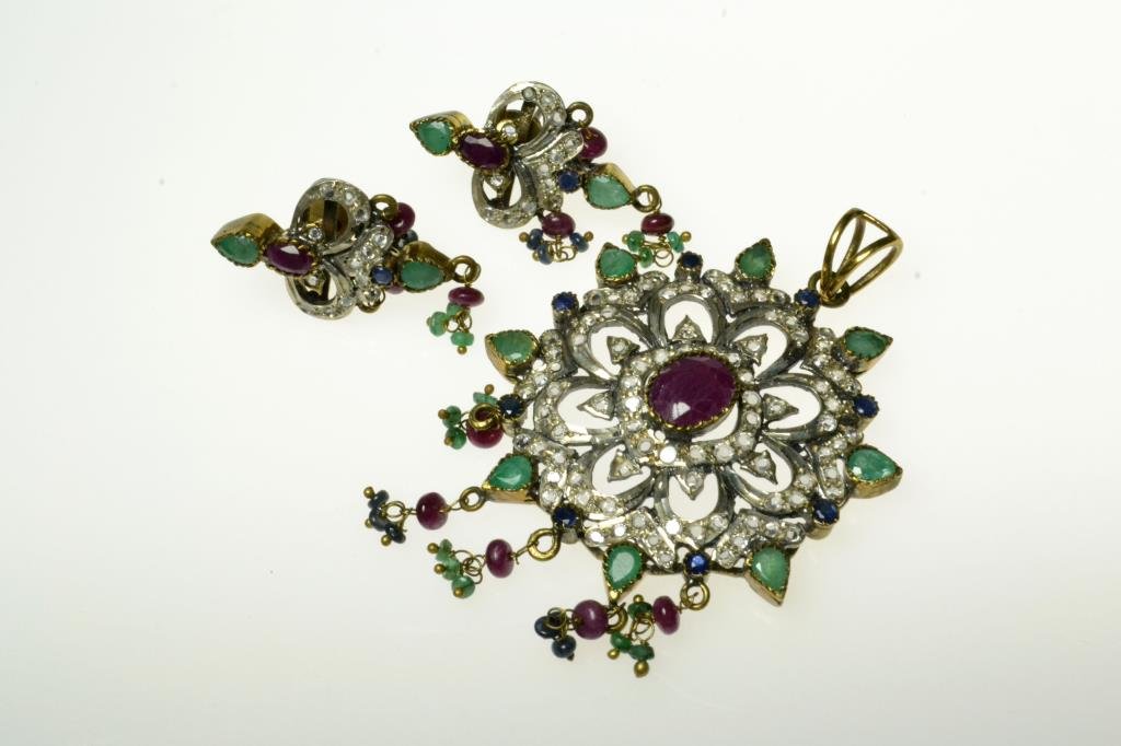 (3) Pcs Sterling & Precious Stone Jewelry Suite: A circular flower shaped pendant with ruby center surrounded by pave set crystals, sapphires, and emeralds with matching post earrings, circa 20th century, pendant measures 3"L, total weight 27.2g. Pr