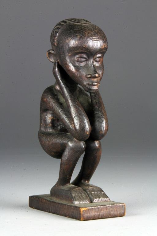 Antique African Carved Wood Figure: A finely carved figure of a young male kneeling, having a deep surface patina atop a rectangular base, measures 11"H, circa late 19th-early 20th century. Condition, some wear to surface commiserate to