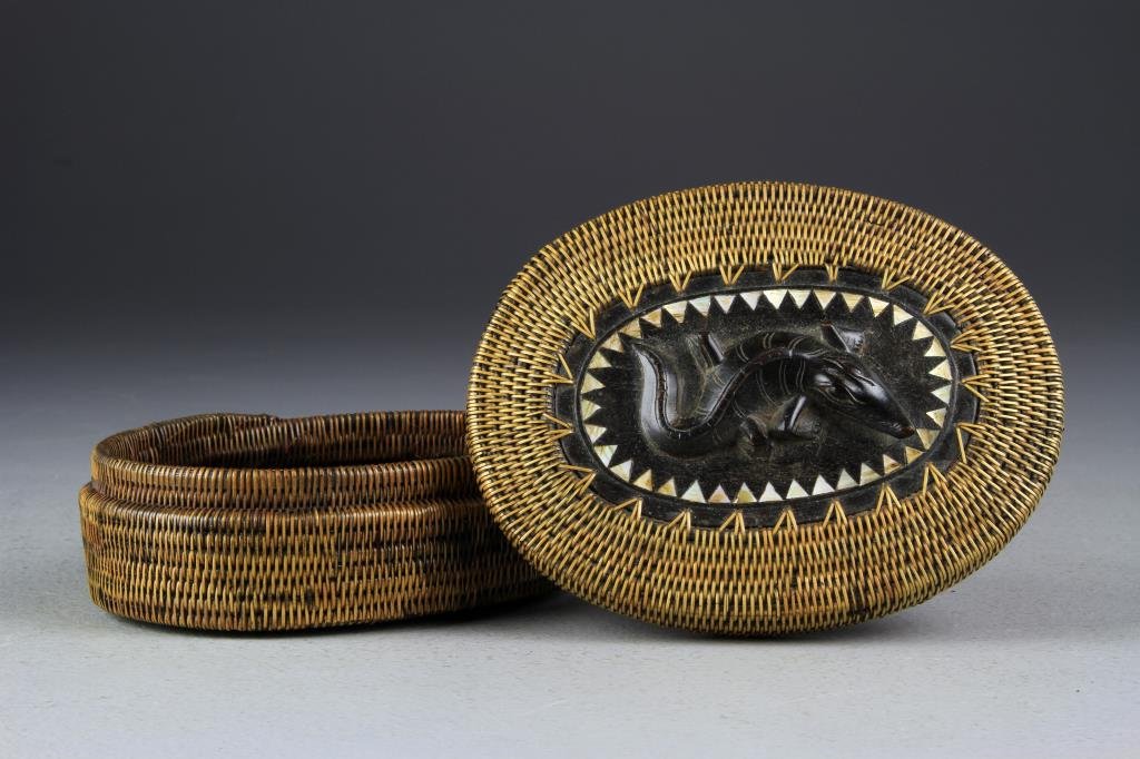 A Fine African Pine Needle & Rosewood Basket: A lidded basket with rosewood bottom and top inlaid with MOP, and having a finely carved crocodile as it's finial, 6.25"W, circa early 20th century.