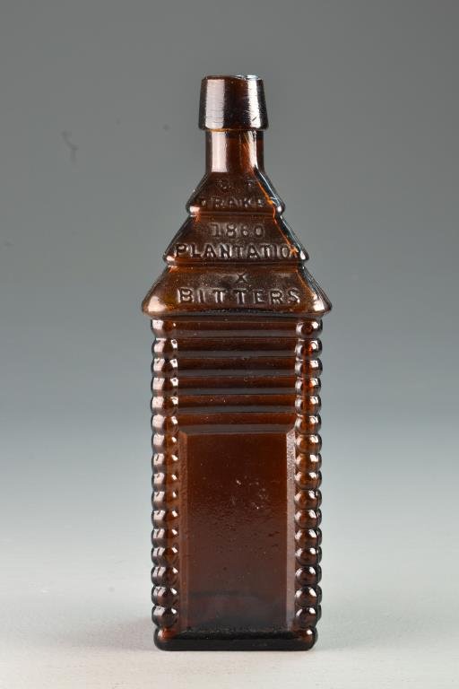 Drakes, 1860 Platation X Bitters Bottle: America, 1860-1880, tall log cabin form, 6 log in deep Amber applied sloping collarded mouth, 10" H condition with normal wear commensurate with age.