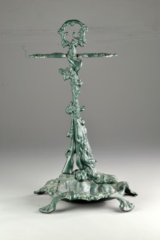 Victorian Cast Iron Umbrella Stand: Depicting a hunting motif with dog and rifle, having an older green painted surface, 20"H, circa early 20th century. Private collection of an Oxford, Michigan lady.