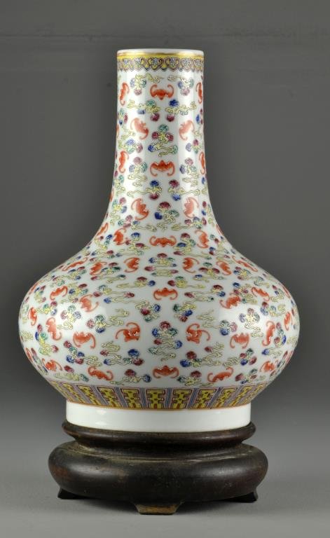 Chinese Thousand Bat Porcelain Vase: Finely enameled to depict a thoudand bats amongst royi, having a six character mark in iron red to underside, 13"H vase only, raised on hardwood stand, circa 19-20th century. Property of a Clinton Tow