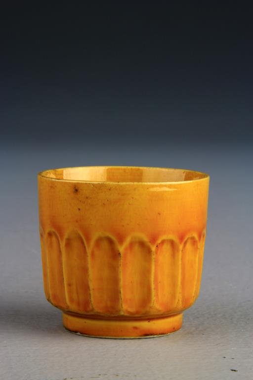 Chinese Qing Monochrome Porcelain Cup: Covered all over in a deep egg yolk glaze and having six character mark to underside, 2"H, circa 19th century. Collection of the Late Robert Willis owner of R.F. Willis Galleries, Grand Rapids, Michig