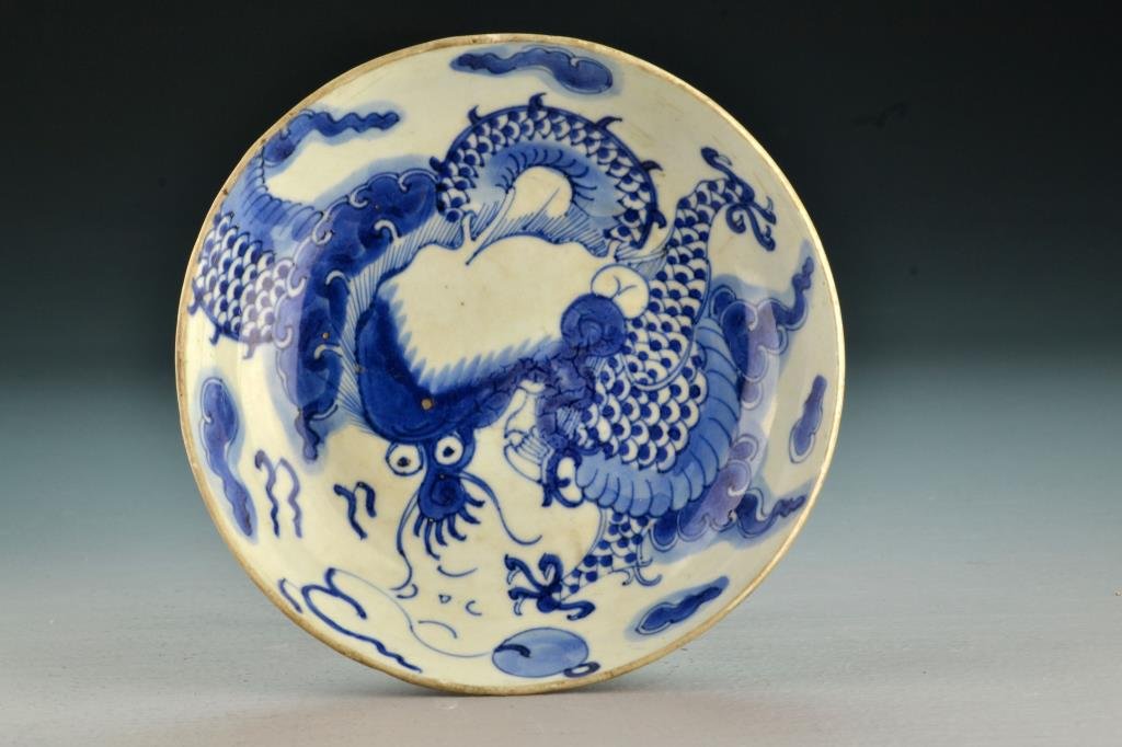 Chinese Qing Blue & White Porcelain Bowl: Finely painted to depict a four clawed dragon amongst ruyi clouds, with black painted signature and two red seal stamps to underside, 6.25" D circa 19th Century. Collection of the Late Robert Willis o