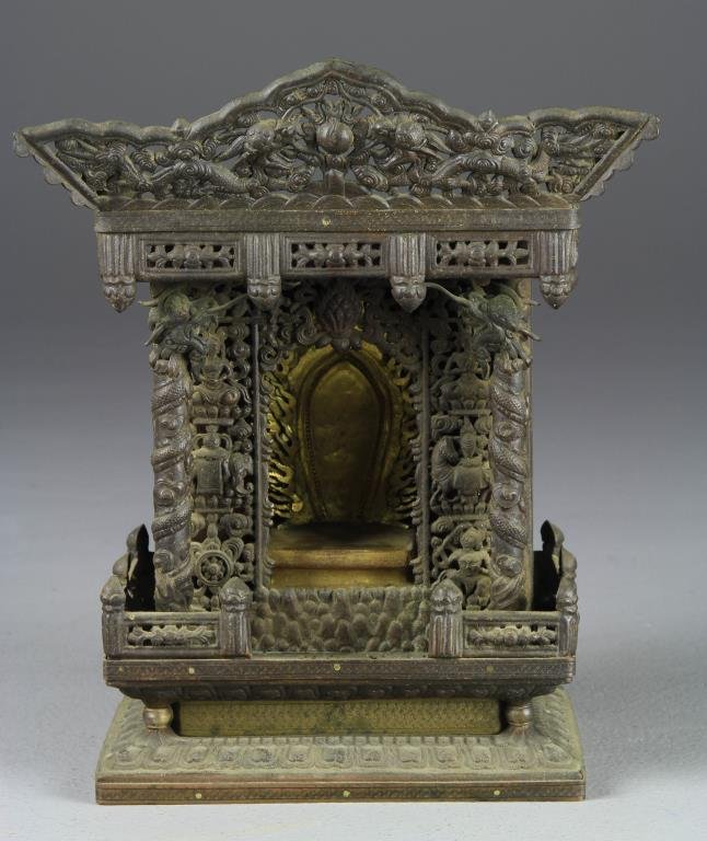 A Japanese Mixed Metal Shrine Meiji Period: Finely chased to depict figures, buddha and animals and having a gilt metal throne, 10.5" H, circa late 19th-early 20th century. Collection of the Late Robert Willis owner of R.F. Willis Galleries, Gr