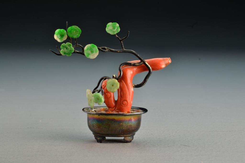 Chinese Coral and Jade Tree in Silver Planter: The coral and jade carved to depict lotus and lingzi having silver branches and flower pot stamped silver, 3.5" H circa early 20th Century. Collection of the Late Robert Willis owner of R.F. Willis Ga