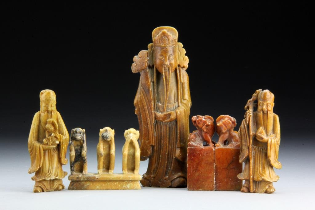 (6) Pieces Chinese Qing Carved Soapstone: To include two seal chops with foo dog finials, a carved monkey grouping and three figures, largest measures 6.5" H, circa late 19th-early 20th century.