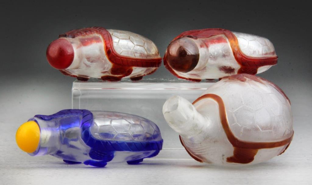 (4) Pcs Chinese Peking Glass Snuff Bottles: Finely carved turtle overlay that extends around bottle with incised shell design, one with coy fish depicted on shell and bottle neck carved into form of turtle's head, tallest is 2.75"H. Condition:
