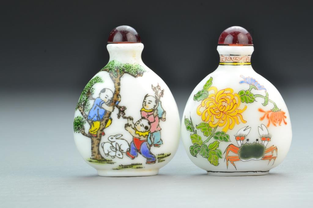 (2) Chinese Peking Glass Snuff Bottles: Finely painted to depict children with bats and rabbits, other with shrimp, crabs and flowers, bases bearing four character mark in iron red underglaze, complete with stoppers, 3.125"H. From the colle