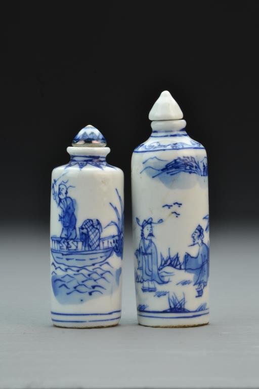(2) Chinese Blue and White Porcelain Snuff Bottles: Finely painted to depict figues within a landscape, the other depicting a man in a boat, decoration at neck, bases bearing seal underglazed in blue, complete with stoppers, tallest is 4.7"H. From the 