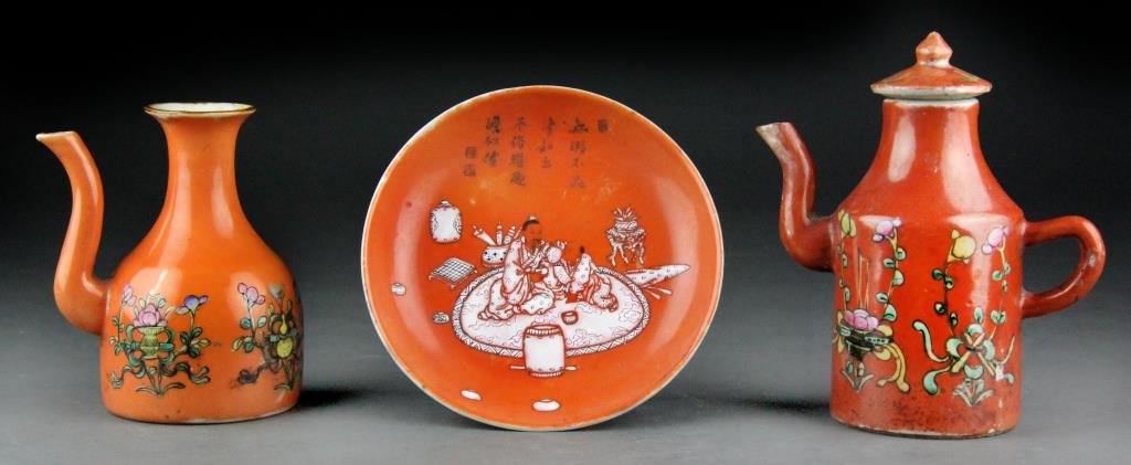 (3) Pcs. Chinese Orange Porcelain Dinnerware: Consisting of three pieces of orange-glazed porcelain: a small floral teapot, a spouted wine container with floral/gourd decoration and a plate showing scholar being served tea with four lines of call