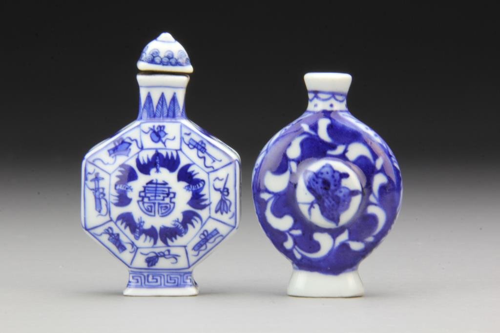 (2) Chinese Blue and White Porcelain Snuff Bottles: Finely painted to depict butterfly at center, other depicting bats and symbols, one base bearing seal, other bearing four character mark in underglaze blue, one lacking stopper, tallest is 3"H. From t