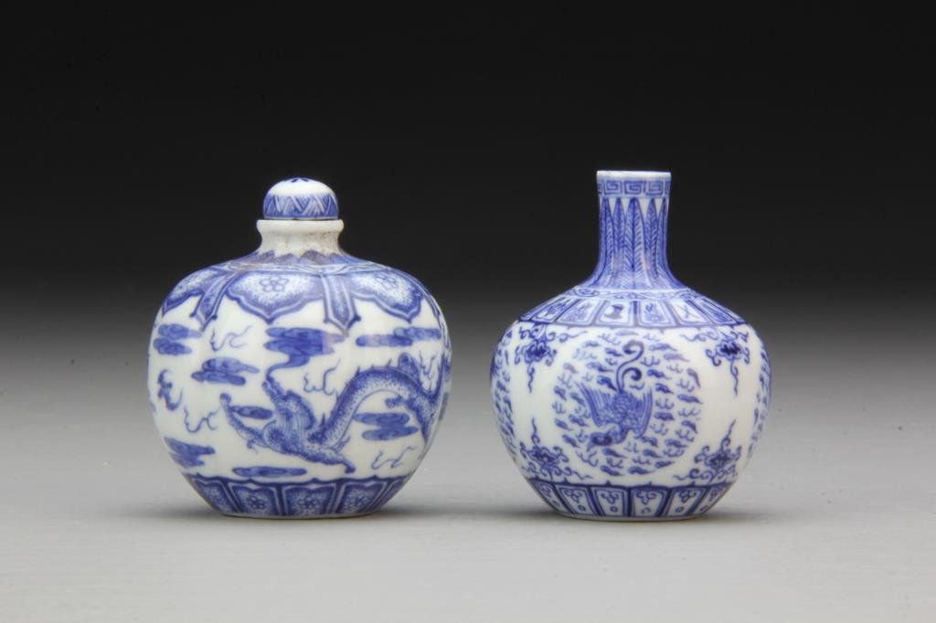 (2) Chinese Blue and White Porcelain Snuff Bottles: Having detailed depiction of dragons and bats among ruyi clouds, other with phoenix, bases bearing three character mark in underglaze blue, tallest is 2.5"H. From the collection of David Bell who work