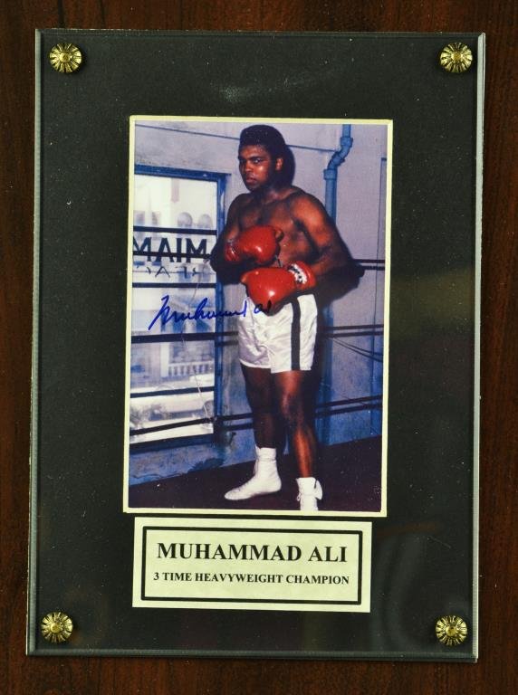 Muhammad Ali Signed Photo On Plaque: Muhammad Ali signed framed photo on plaque 9" H x 7" W, sight & frame, Certificate of Authenticity provided by Autographed Legends LLC.