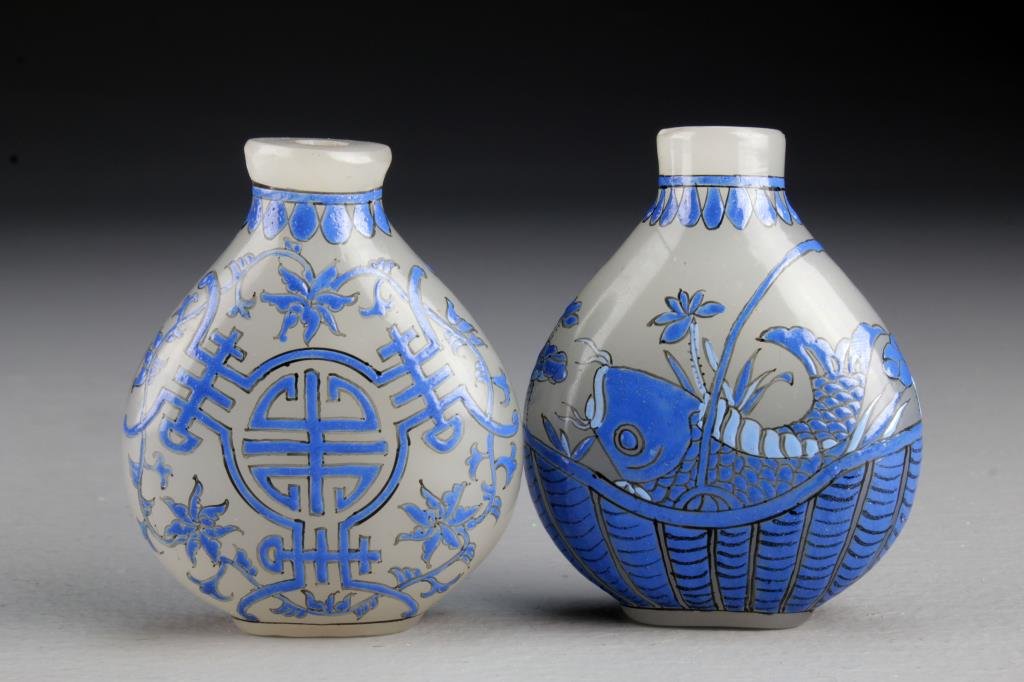(2) Chinese Peking Glass Snuff Bottles: One finely painted with flower and symbol design, other painted to depict koi fish and lotus flowers in basket, bases bearing three character mark in underglaze iron red, tallest is 2.9"H. From the co