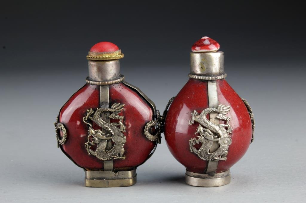 (2) Chinese Porcelain Snuff Bottles: Having metal fixtures depicting four clawed dragons, one also having beast head handles, bases with character mark, one with stopper and metal spoon, tallest is 2.8"H.