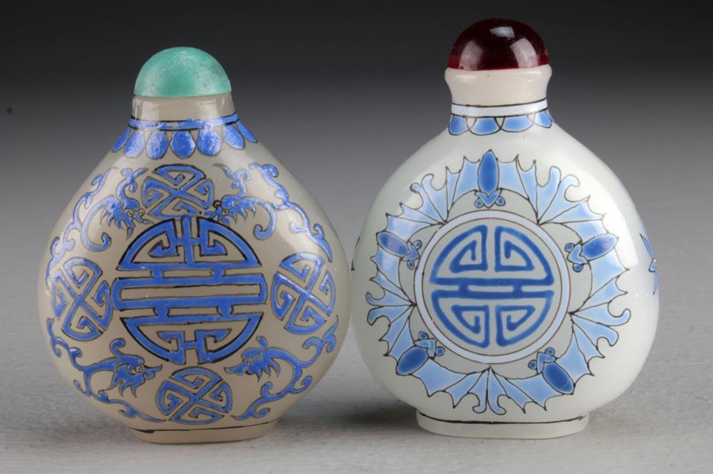 (2) Chinese Peking Glass Snuff Bottles: Finely painted to depict bats and scrolling tendrils surrounding Shou symbols, bases character marked in iron red and blue underglaze, tallest is 3"H.