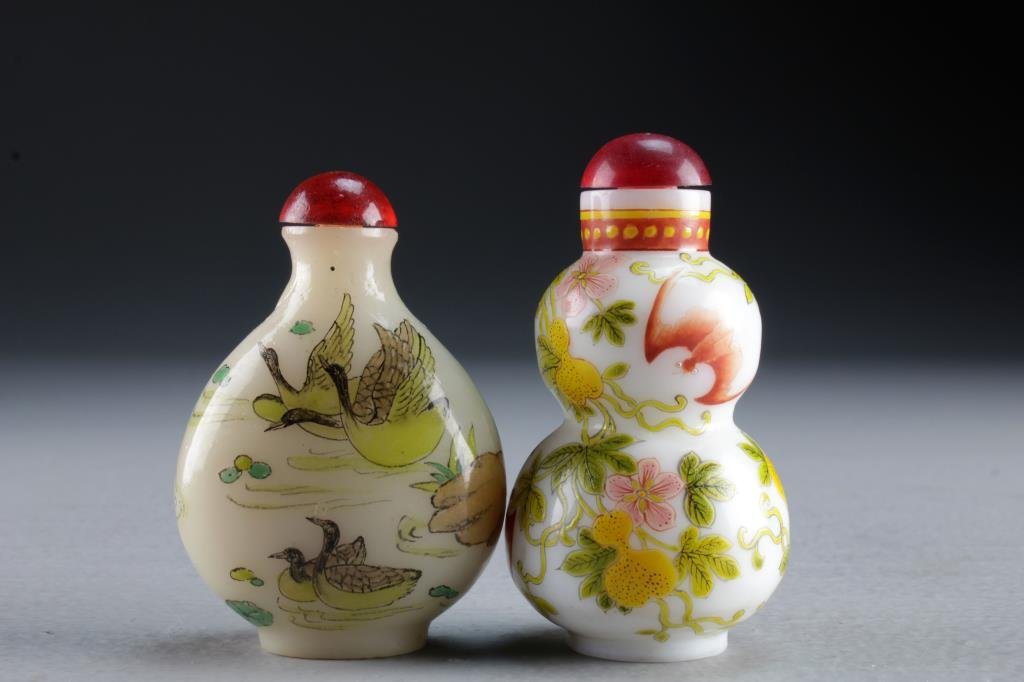 (2) Chinese Peking Glass Snuff Bottles: One formed as gourd and painted to depict bats and gourd plants, base bearing three character mark in iron red, second example painted to depict ducks and lotus flowers on pond, tallest is 2.7"H.