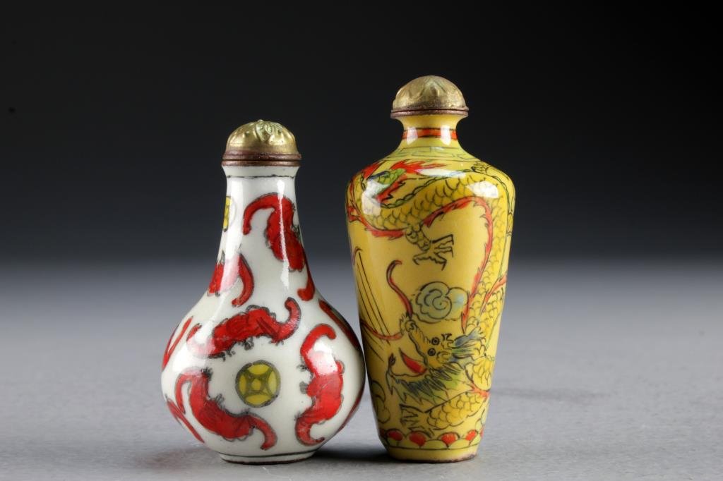 (2) Chinese Enamel Snuff Bottles: To include two small examples, one painted to depict bats with coins, the second bottle depicting four clawed dragons chasing flaming pearl among ruyi clouds, tallest is 2.6"H.