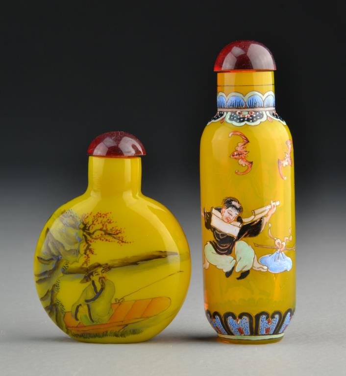 (2) Chinese Peking Glass Snuff Bottles: One a translucent glass example finely painted to depict figures with bats and band of design at base and neck, the second example painted to depict figures in landscape scenes, tallest is 3.6"H.