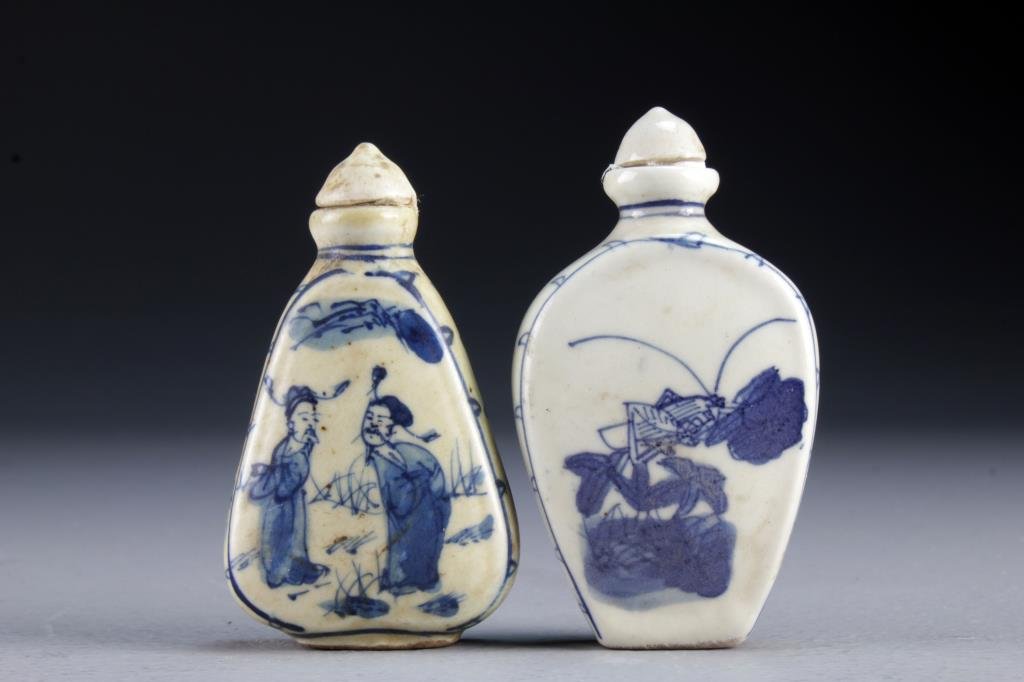 (2) Chinese Blue and White Porcelain Snuff Bottles: One painted at center to depict figures in a landscape, the other depicting cricket and bunches of grapes, bases marked by leaf in underglaze blue, tallest is 3.25"H.
