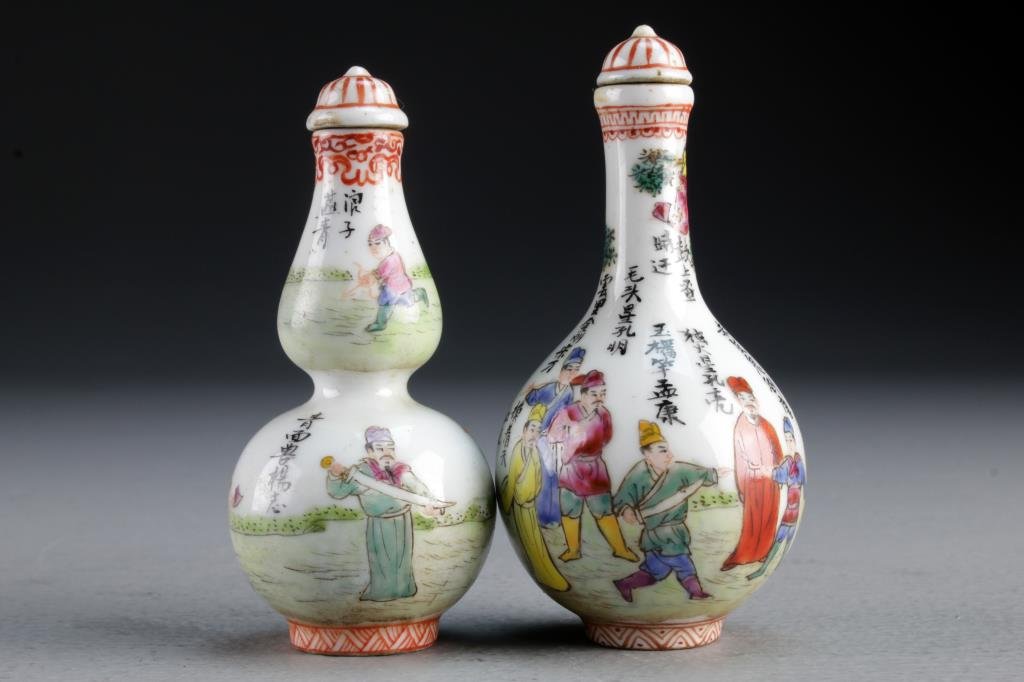 (2) Chinese Famille Rose Porcelain Snuff Bottles: Finely painted to depict figures training with weapons in landscape scenes, each having several lines of calligraphy and iron red detailing, bases bearing four character mark in underglaze iron red, t