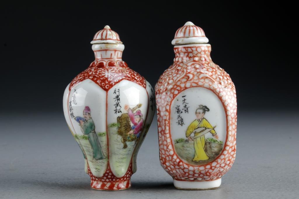 (2) Chinese Famille Rose Porcelain Snuff Bottles: Finely painted to depict figures with weapons in landscape scenes, each having several lines of calligraphy and iron red border designs, bases bearing four character mark in underglaze iron red, talle